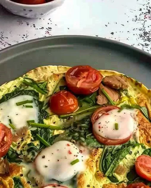 Tortilla de Espinacas y Tomate servida en un plato blanco
